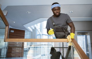 man-cleaning-railing-medium-shot